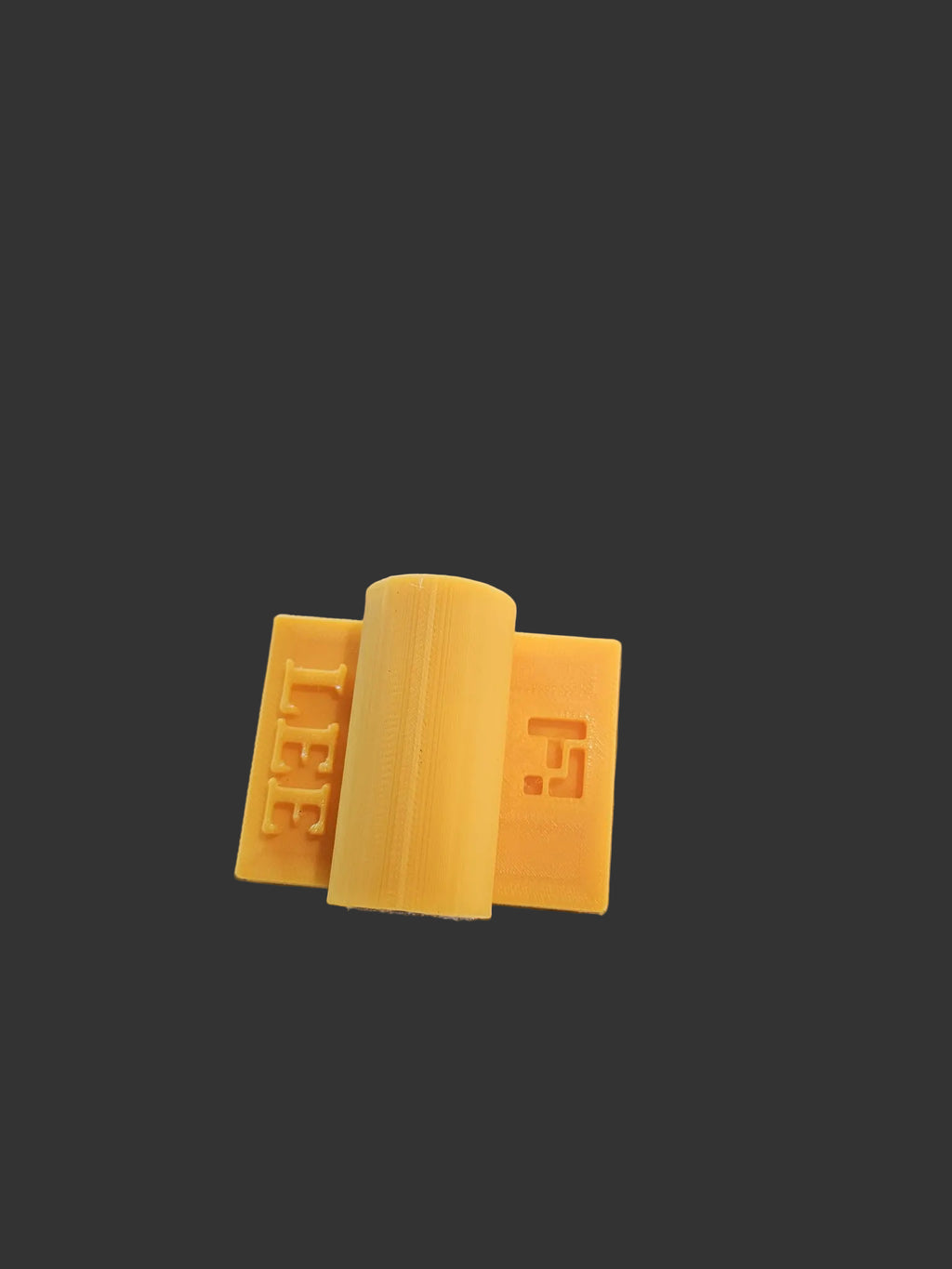 Rail Mate yellow 3D-printed pool table rail bridge close-up showing cue ferrule opening, LH Inventions branding, and rubber grip base on rail edge"
